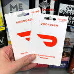 A person holding DoorDash Gift Cards