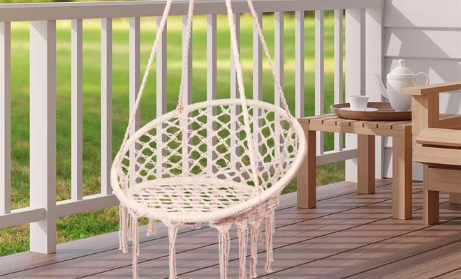 Dakota Fields Ortiz Swing Chair in the Color Beige on a Patio