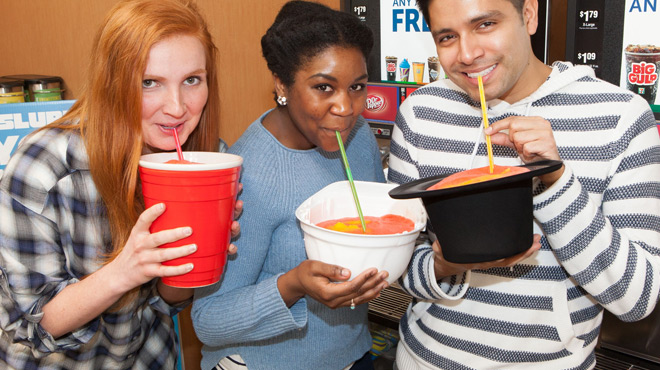 People Holding Creative Cup Filled with 7 Eleven Slurpees