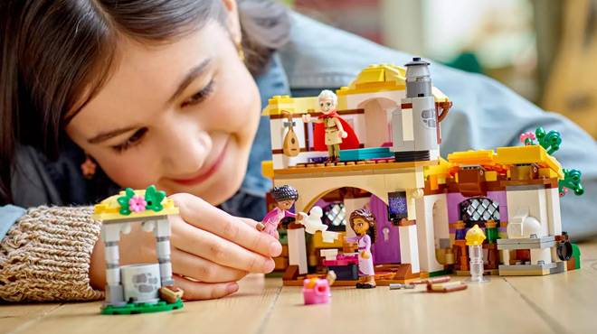 A Child Playing with LEGO Ashas Cottage Set