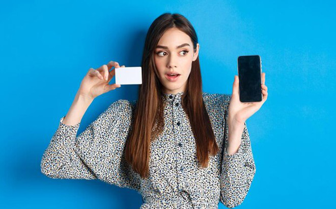 A Girl Holding a Card and a Phone