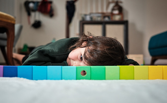 A Kid Looking Through a Hole in a Toy Skills