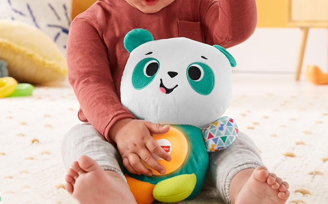 A Little Kid Holding Fisher Price Linkimals Play Together Panda