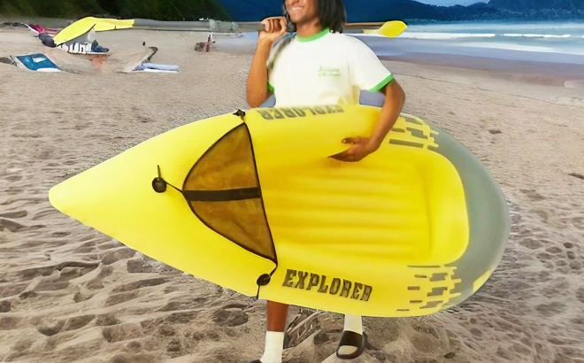 A Man Holding an Inflatable Kayak