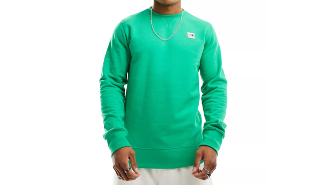 A Man Wearing The North Face Heritage Patch Sweatshirt
