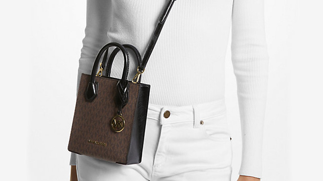 A Person Carrying a Michael Kors Extra Small Logo Crossbody Bag