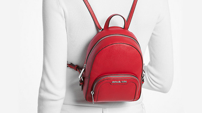 A Person Carrying a Michael Kors Extra Small Pebbled Leather Backpack