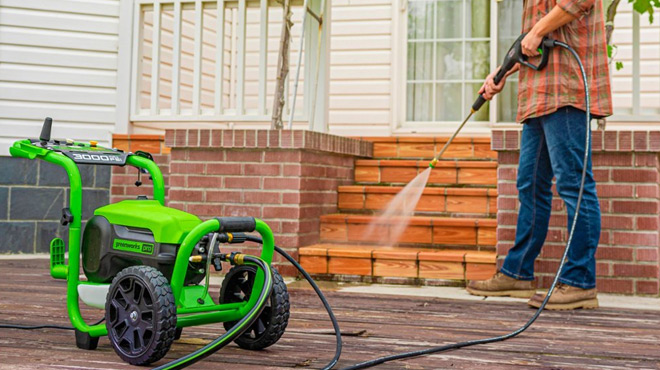 A Person Cleaning using a Greenworks Electric Pressure Washer