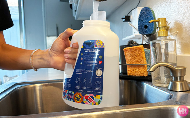 A Person Filling up Laundry Wash Bottle