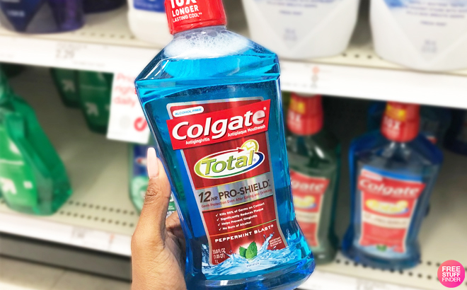 A Person Holding Colgate Total Mouthwash in Peppermint