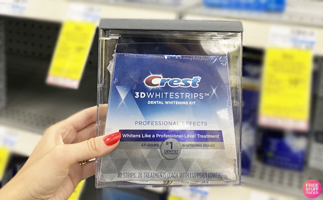 A Person Holding Crest 3D Whitestrips Professional Effects Whitening Kit