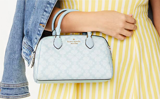A Person Holding Kate Spade Flower Dolly Duffle Crossbody