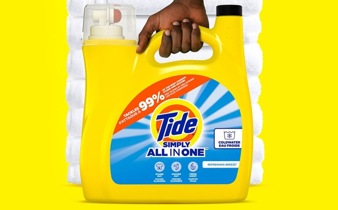 A Person Holding Tide Simply Clean Fresh Liquid Laundry Detergent