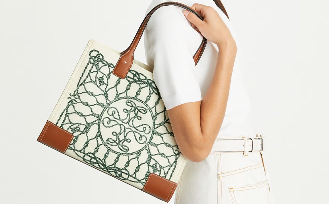 A Person Holding Tory Burch Small Ella Printed Tote in Ivory Abstract Rope Color