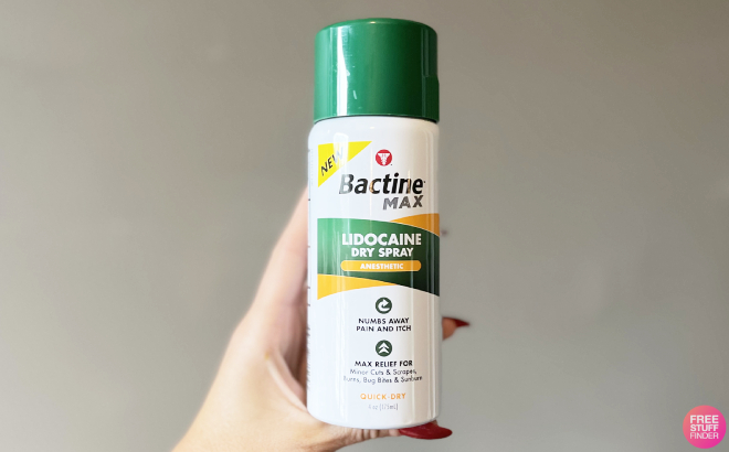 A Person Holding a Bottle of Bactine Max Dry Spray