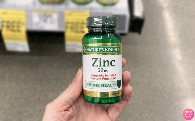 A Person Holding a Bottle of Natures Bounty Zinc 50mg Supplement