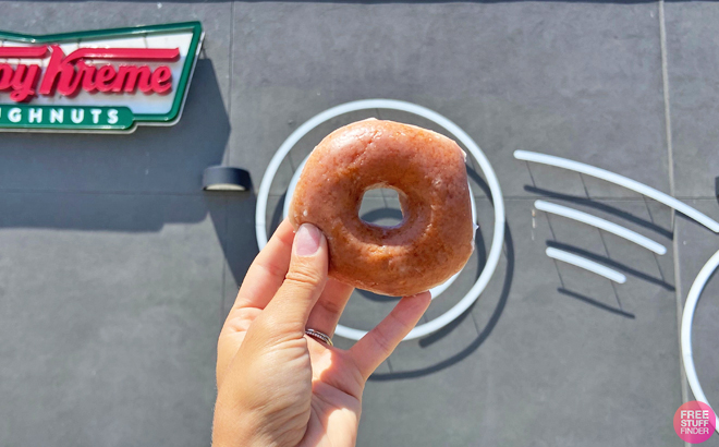 A Person Holding a Krispy Kreme Donut