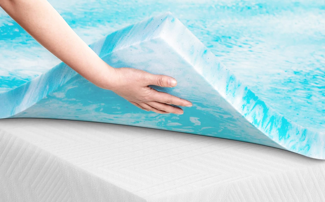 A Person Holding a Memory Foam Mattress Topper