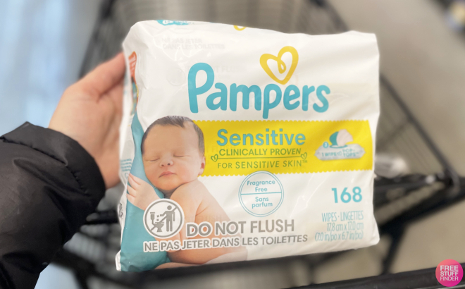 A Person Holding a Pack of Pampers Sensitive Baby Wipes 168 Count