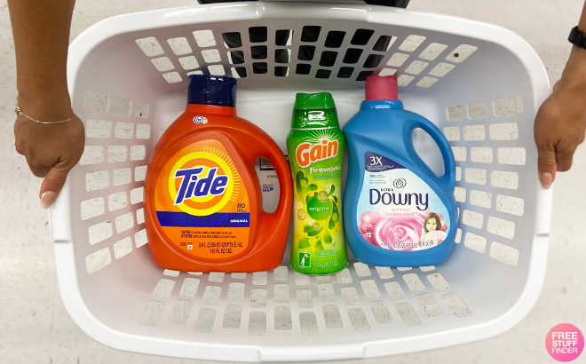 A Person Holding a Plastic Basket Filled with Tide Gain and Downy Products