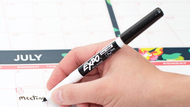 A Person Using EXPO Low Odor Dry Erase Marker in Black Color