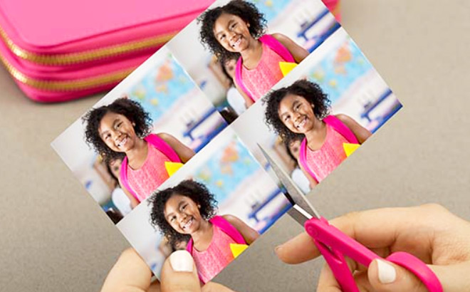 A Person Using Scissors to Make Four Wallet Photo Prints