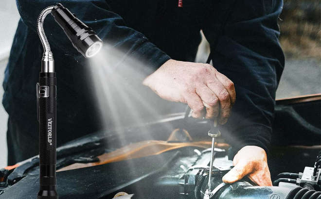 A Person Using Veitorld Extendable Magnetic Flashlight While Fixing Car