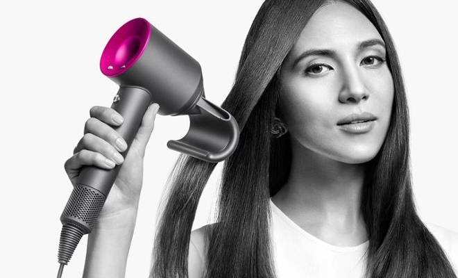 A Person Using the Dyson Supersonic Hair Dryer in the Color Iron Fuchsia