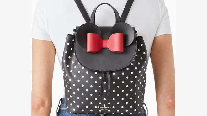 A Person with Disney X Kate Spade Minnie Mouse Backpack