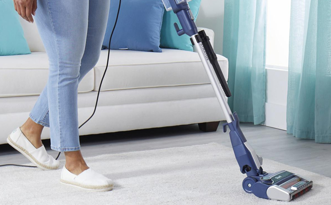 A Woman Cleaning with the Shark Stratos Ultralight DuoClean & PowerFins HairPro Vacuum