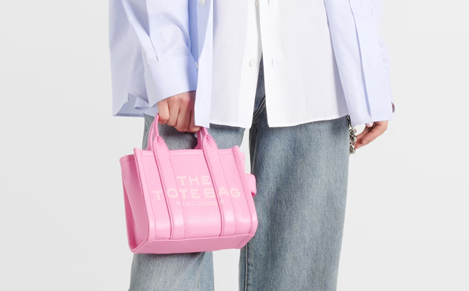 A Woman Holding Marc Jacobs Mini Logo Leather Tote Bag