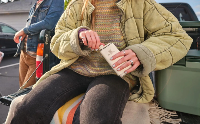 A Woman Holding Stanley Legendary Classic Pre Party Liquor and Spirit Flask