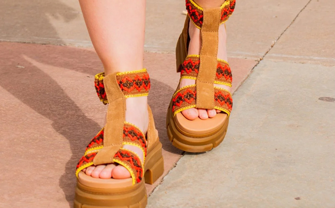 A Woman Walking in the UGG Ashton Heritage Braid Sandals