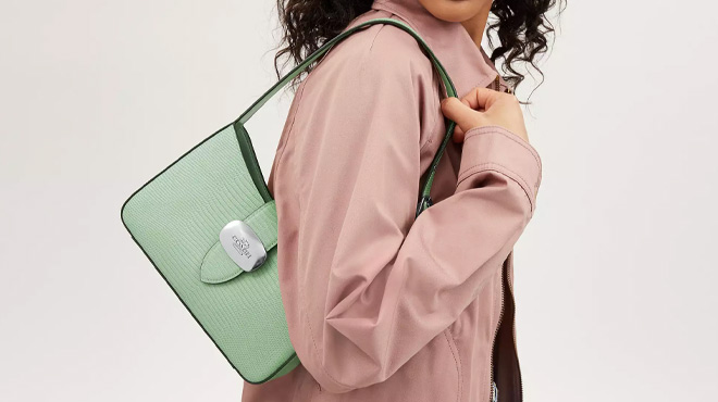 A Woman Wearing Coach Outlet Eliza Shoulder Bag in Pale Green