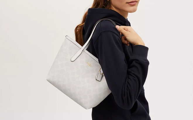 A Woman Wearing Coach Outlet Mini City Tote In Signature Canvas