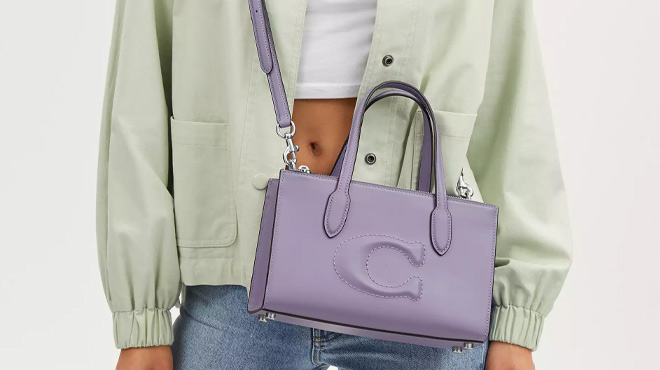 A Woman Wearing Coach Outlet Nina Small Tote Bag