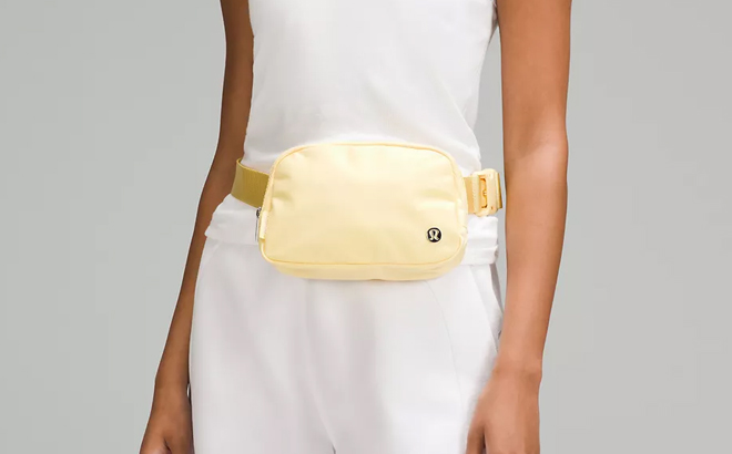 A Woman Wearing Lululemon Everywhere Belt Bag in Swirl Yellow