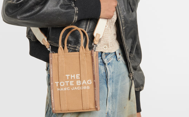 A Woman Wearing Marc Jacobs The Jacquard Canvas Phone Pouch