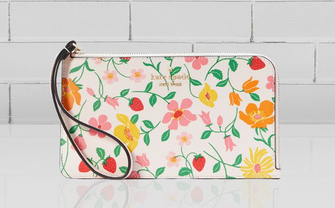 Kate Spade Lucy Garden Medium L zip Wristlet on the Table