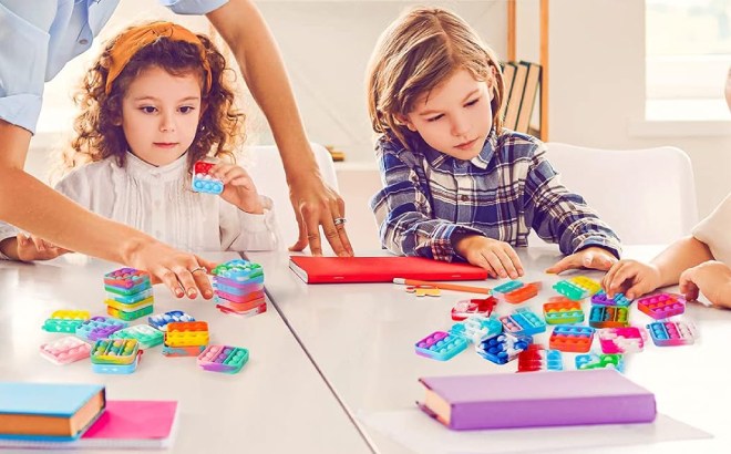 Kids Playing with Mini Pop Fidget Keychain Toys in a Classroom