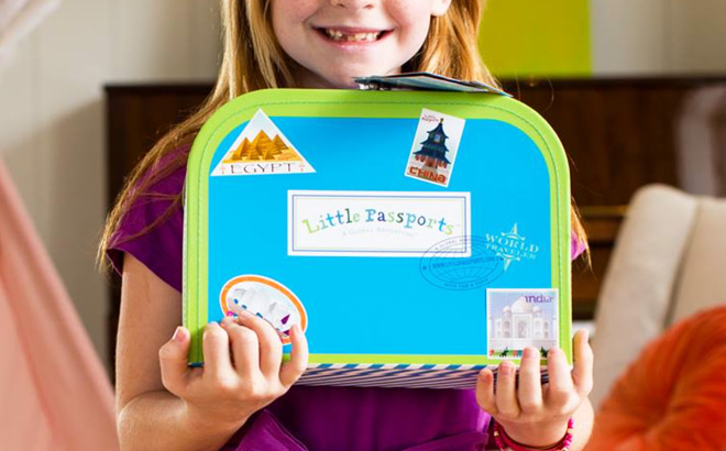 Little Girl Holding a Blue Little Passports Suitcase