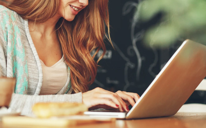 Young Women Typing on a Laptop