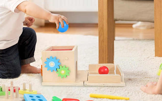 a Child Playing with a Wooden Baby Toys Play Kit