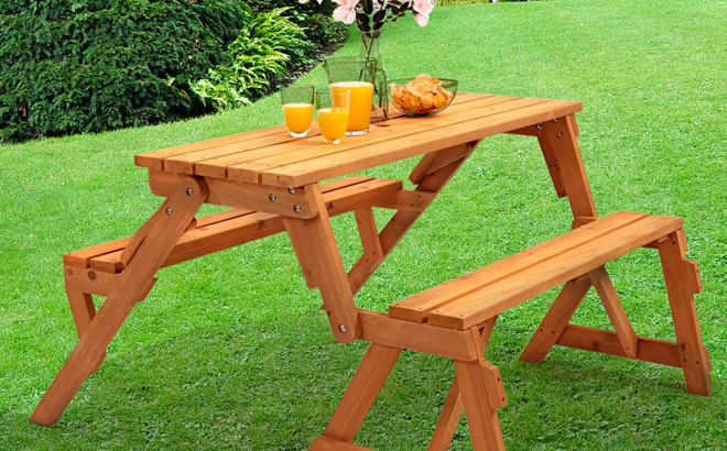 2 in 1 Interchangeable Wooden Picnic Table in a Garden with Food and Drinks on it