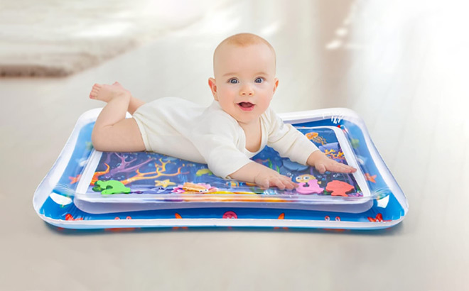 A Baby is Laying on the Tummy Time Water Mat