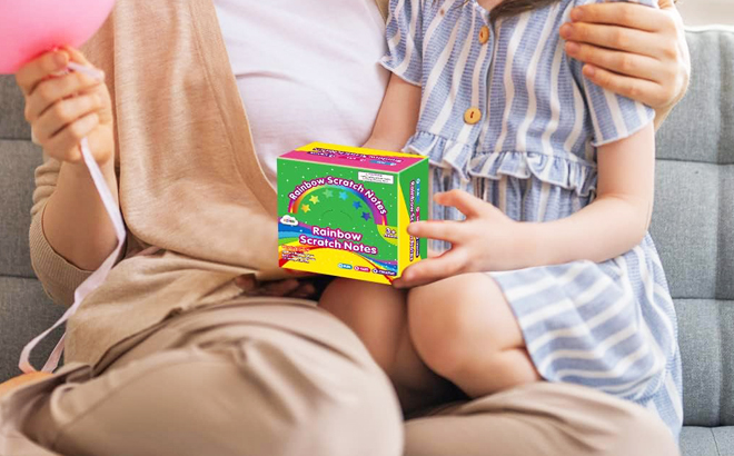 A Child Holding a Box of Rainbow Scratch Mini Art Notes