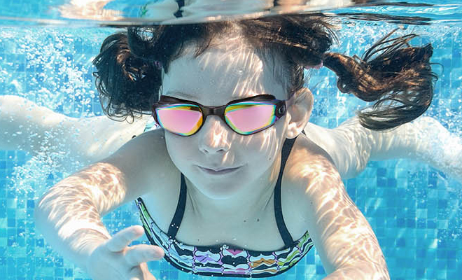 A Child Swiming in a Pool With Swimming Goggles