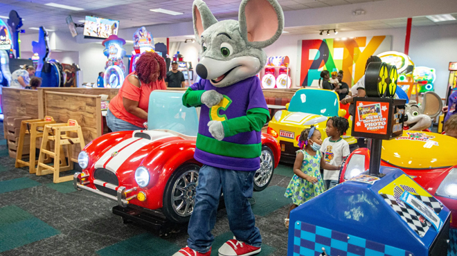 A Chuck E Cheese Mascot Playing with Kids