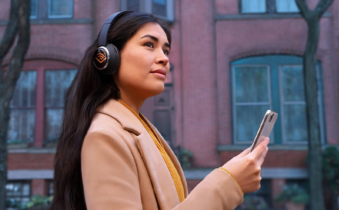 A Girl Holding a Phone with Headphones In