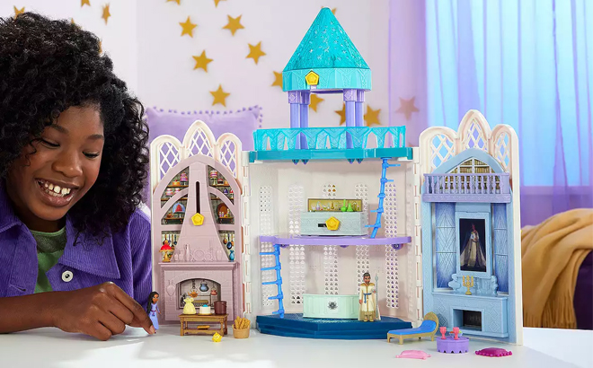 A Girl Playing with the Disney Wish Rosas Castle Playset